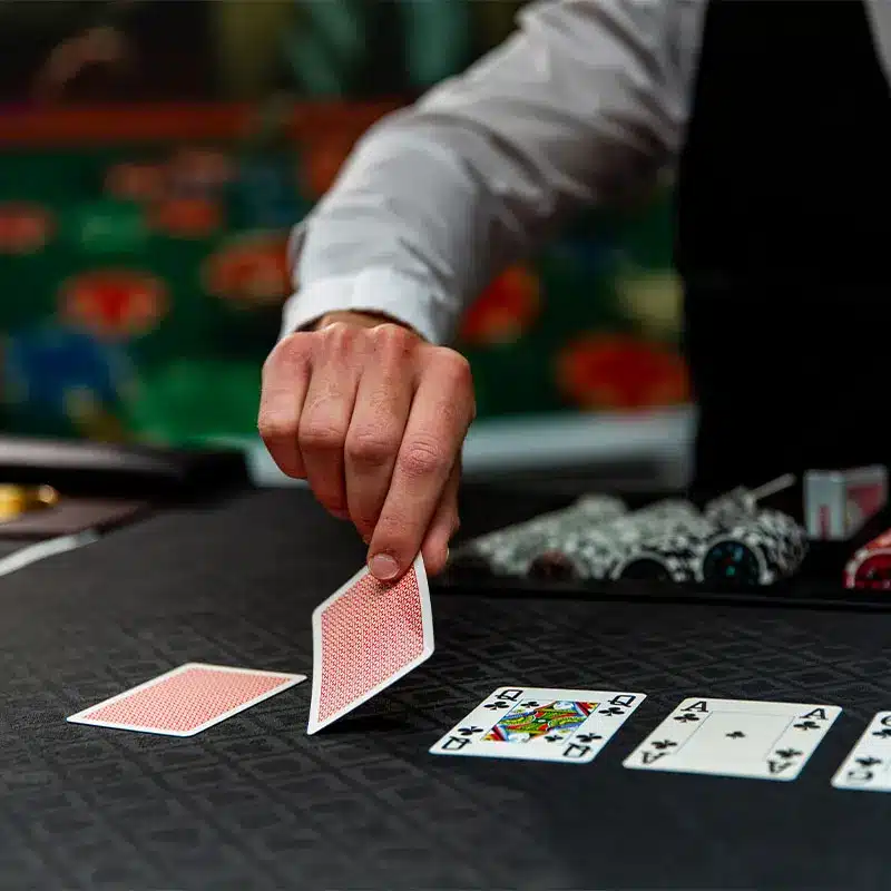 Croupier deelt speelkaarten op de pokertafel